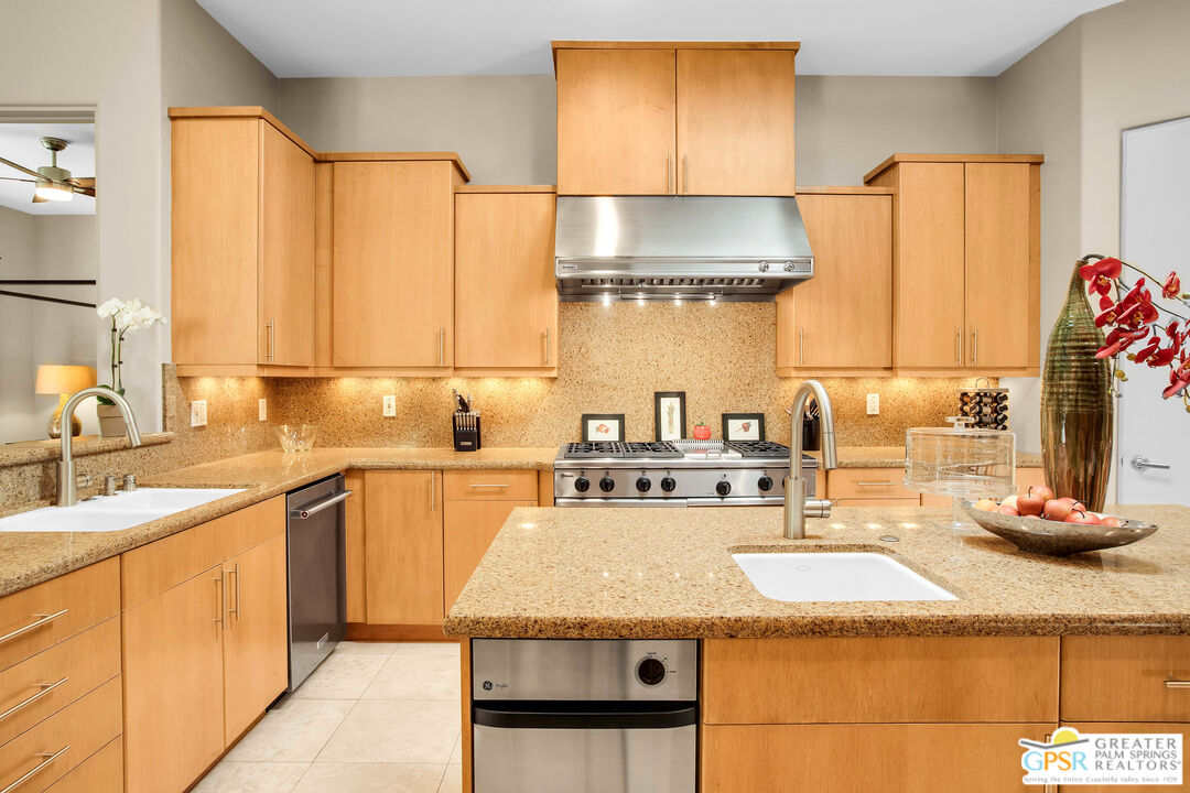 39700 Keenan Drive Rancho Mirage, CA 92270 - Photo 44 of 69 a kitchen with stainless steel appliances granite countertop a sink and cabinets