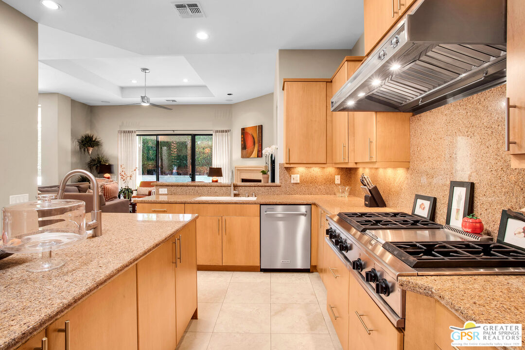 39700 Keenan Drive Rancho Mirage, CA 92270 - Photo 45 of 69 a kitchen with stainless steel appliances granite countertop a sink stove and refrigerator