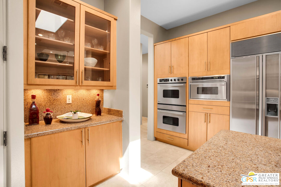 39700 Keenan Drive Rancho Mirage, CA 92270 - Photo 46 of 69 a kitchen with stainless steel appliances granite countertop a stove a sink and a refrigerator