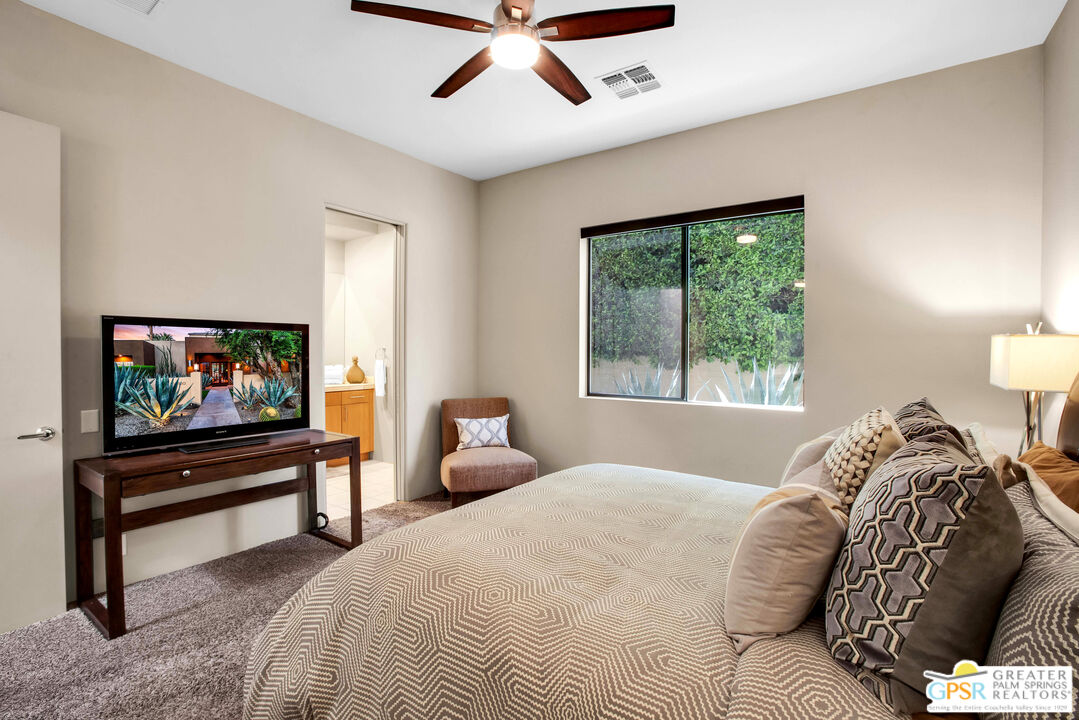 39700 Keenan Drive Rancho Mirage, CA 92270 - Photo 61 of 69 a bedroom with a bed and a flat screen tv