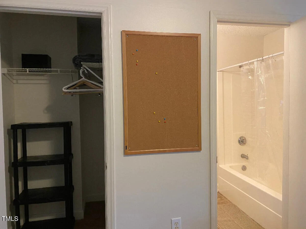 303 Smith Level Road, Unit E33 Chapel Hill, NC 27516 - Photo 11 of 25 a bathroom with a bathtub and a shower