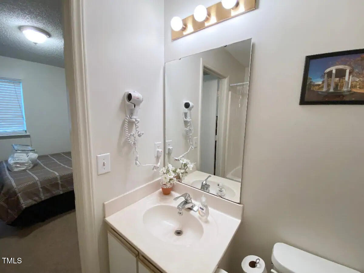 303 Smith Level Road, Unit E33 Chapel Hill, NC 27516 - Photo 12 of 25 a en suite bathroom with a sink and a mirror