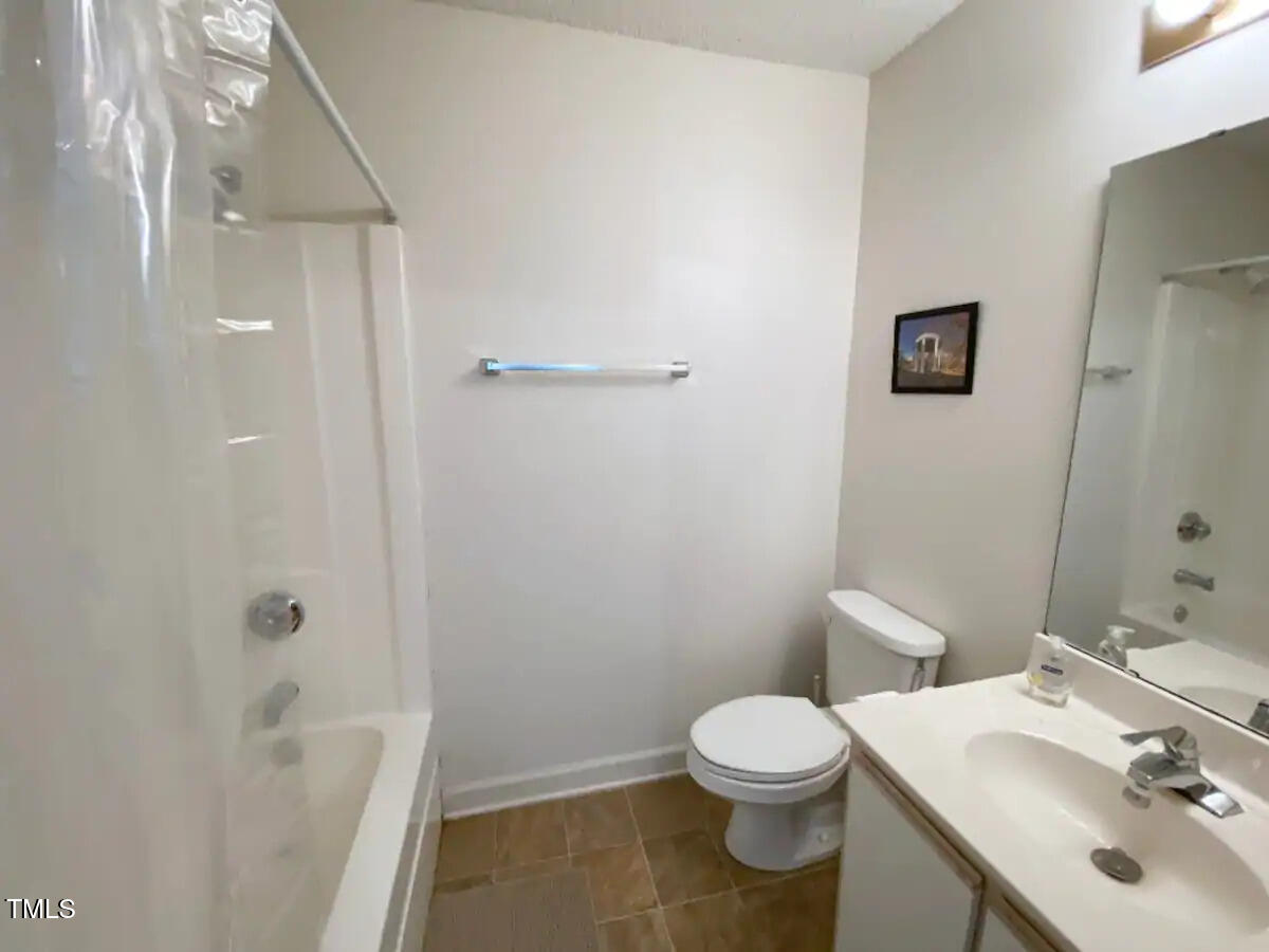 303 Smith Level Road, Unit E33 Chapel Hill, NC 27516 - Photo 13 of 25 a bathroom with a sink a toilet and shower