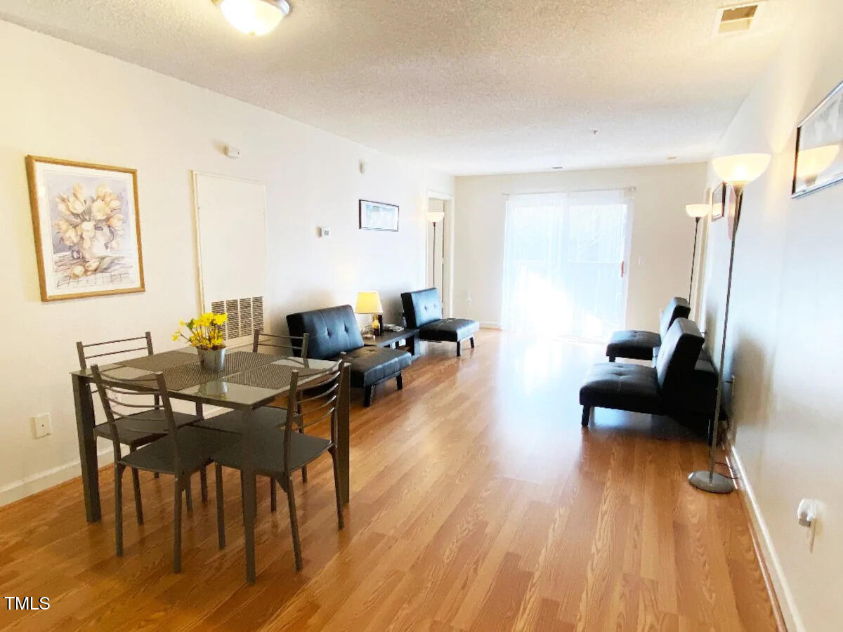303 Smith Level Road, Unit E33 Chapel Hill, NC 27516 - Photo 3 of 25 a living room with furniture and a wooden floor