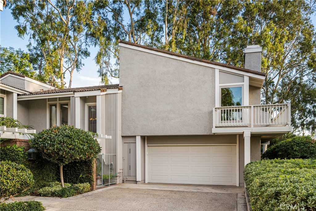 a front view of a house with plants