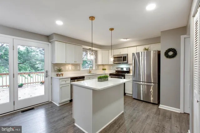 a kitchen with sink cabinets and dining table
