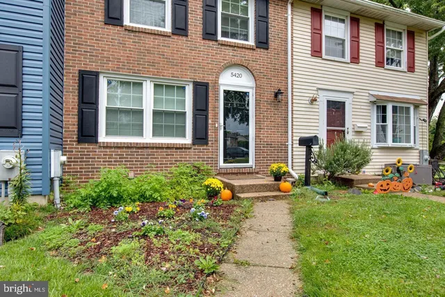 a view of a house with sitting area and garden