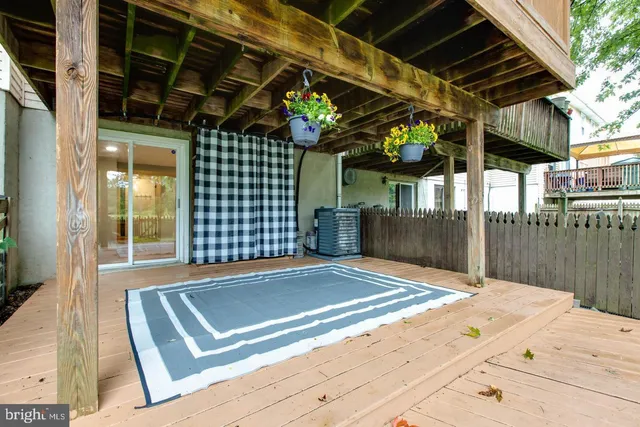 a front view of a house with a garden and trees