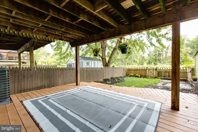 a view of a yard with wooden deck