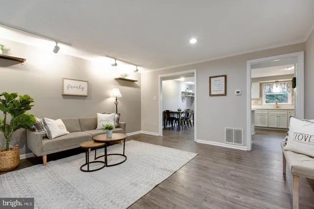 a living room with furniture and wooden floor