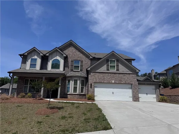 a front view of a house with a yard and garage