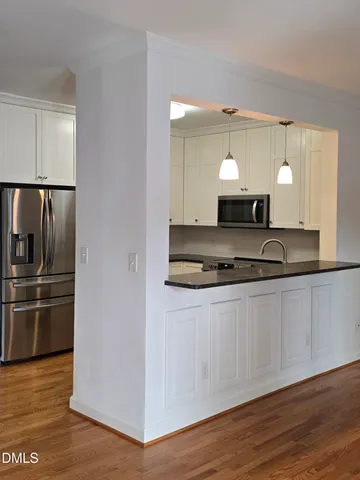 a kitchen with granite countertop a refrigerator and a stove
