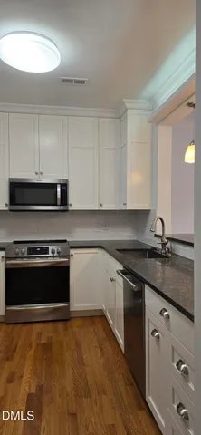 a kitchen with granite countertop a stove and a sink