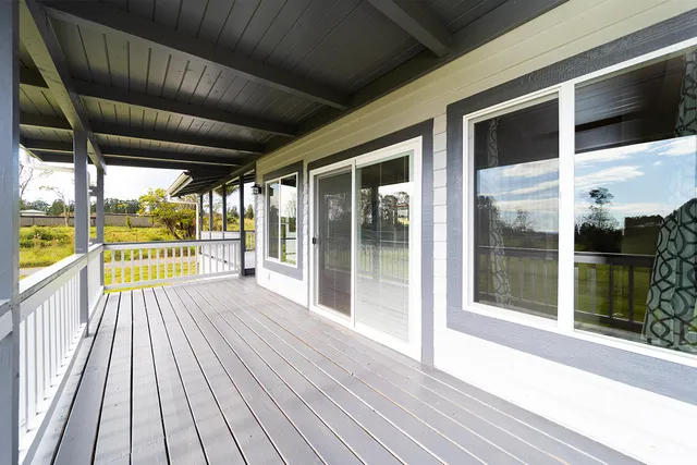 a view of outdoor space with wooden floor and windows