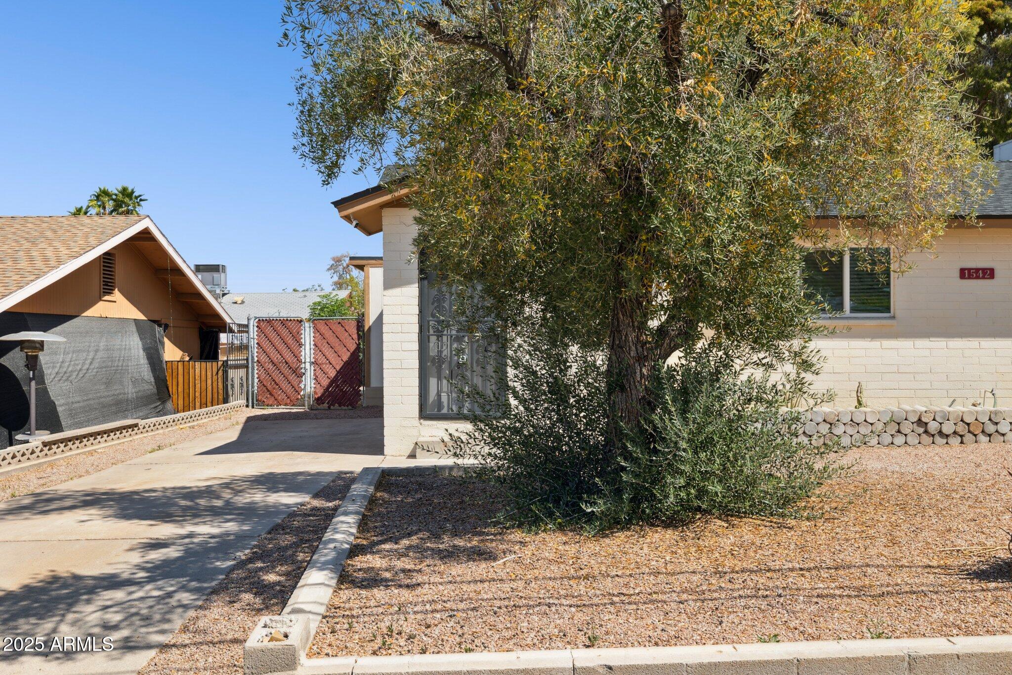 1542 East Turquoise Avenue, Unit 1 Phoenix, AZ 85020 - Photo 1 of 25 a view of a house with a yard