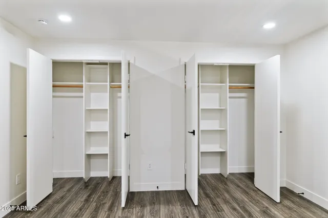 a view of walk in closet with wooden floor