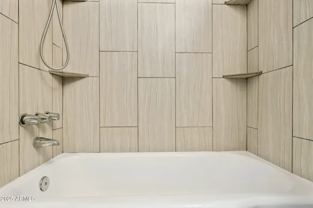 a bathroom with a bathtub and a shower