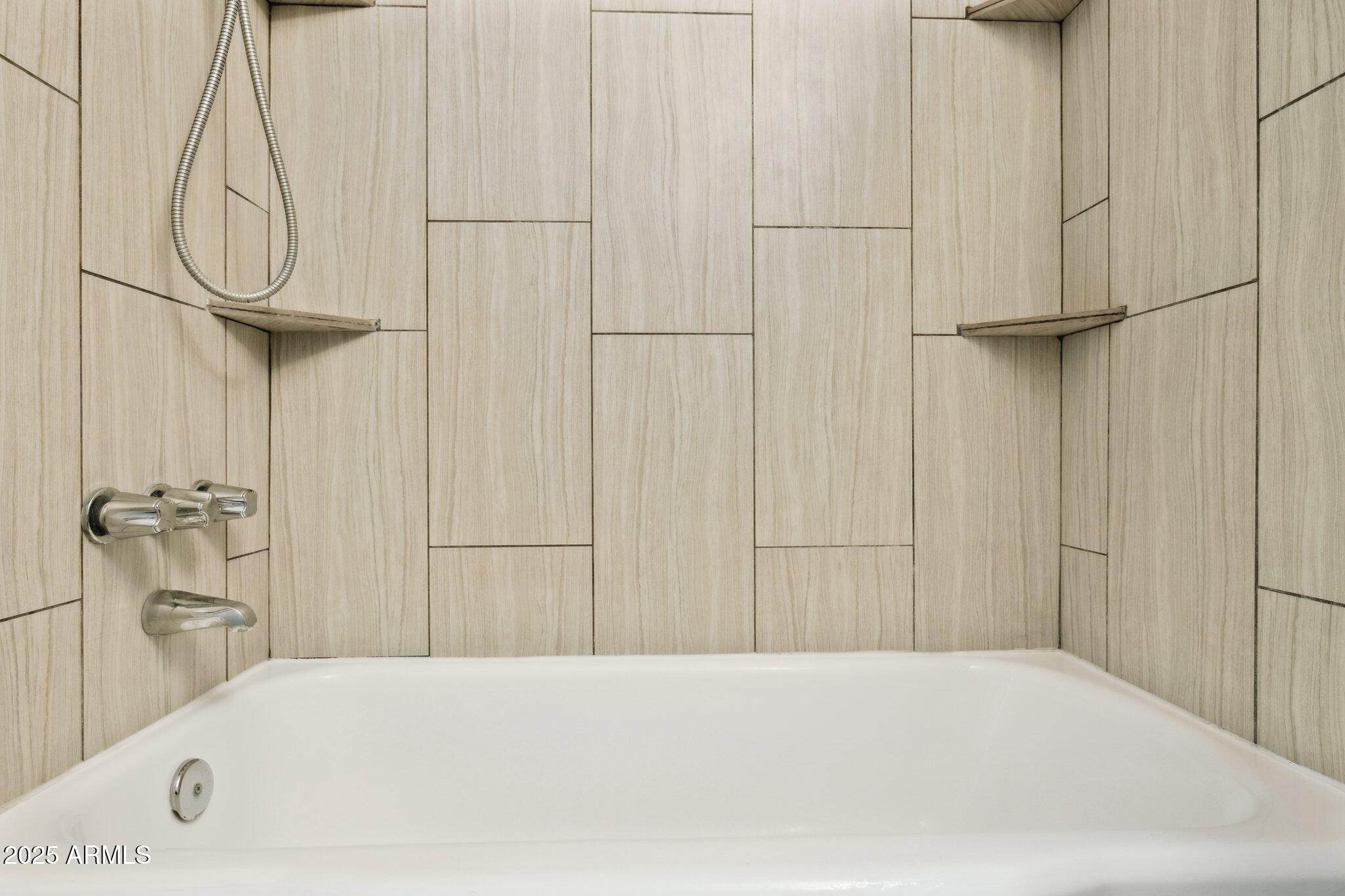 1542 East Turquoise Avenue, Unit 1 Phoenix, AZ 85020 - Photo 15 of 25 a bathroom with a bathtub and a shower