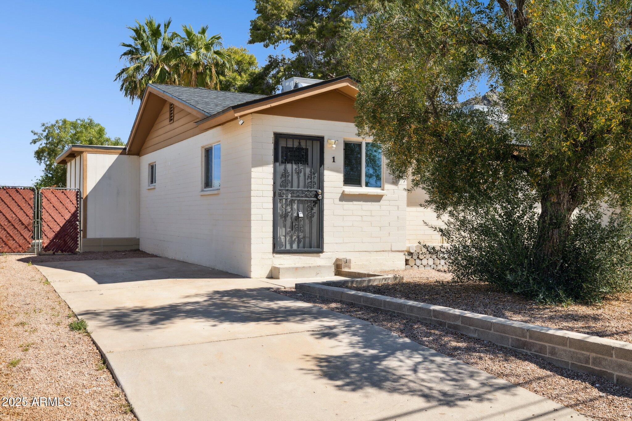 1542 East Turquoise Avenue, Unit 1 Phoenix, AZ 85020 - Photo 2 of 25 a view of a house with a yard