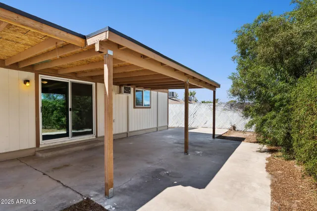 a porch with a table and chairs