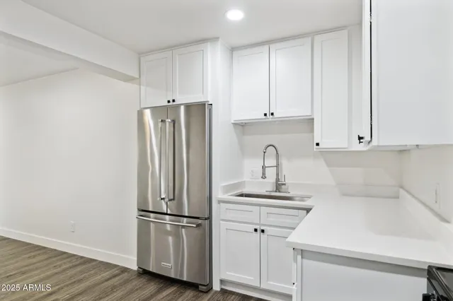 a kitchen with a refrigerator sink and cabinets