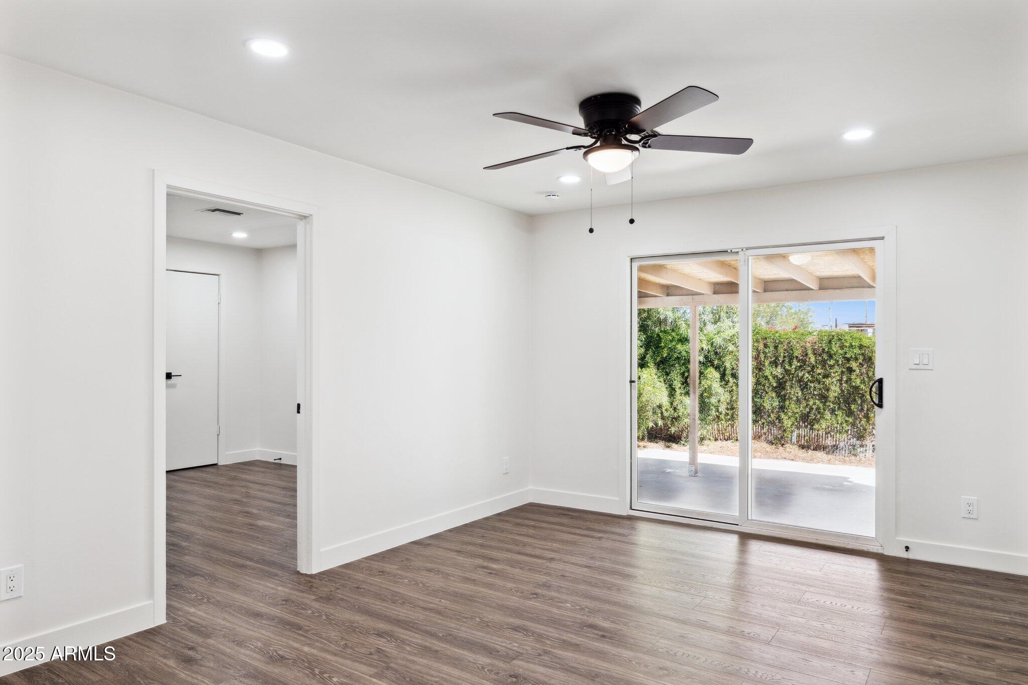 1542 East Turquoise Avenue, Unit 1 Phoenix, AZ 85020 - Photo 9 of 25 a view of an empty room with wooden floor and a window