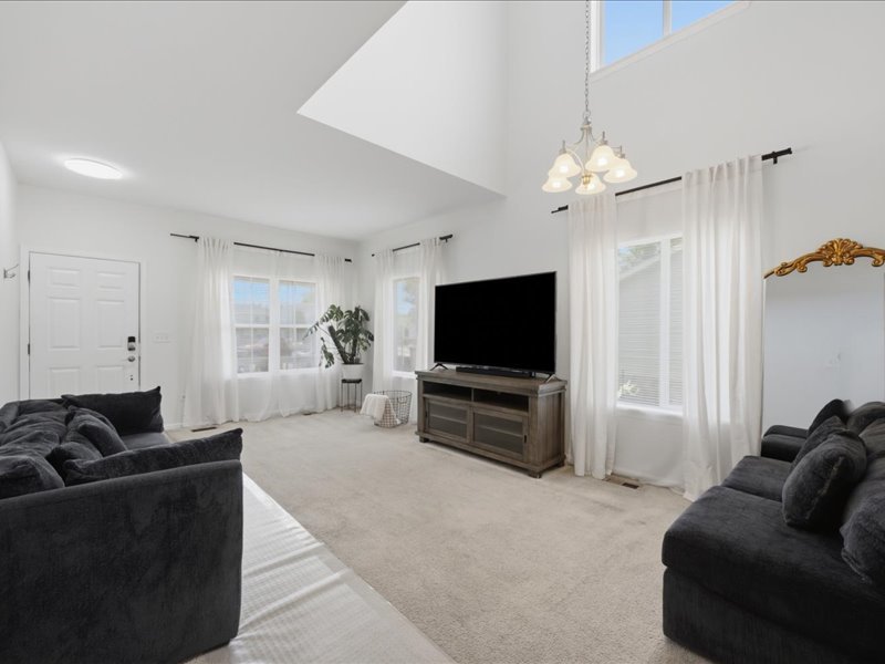 4201 Dillon Street Plano, IL 60545 - Photo 3 of 37 a living room with furniture and a flat screen tv