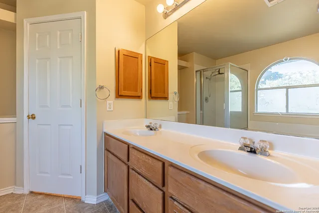 a bathroom with a granite countertop sink mirror and double