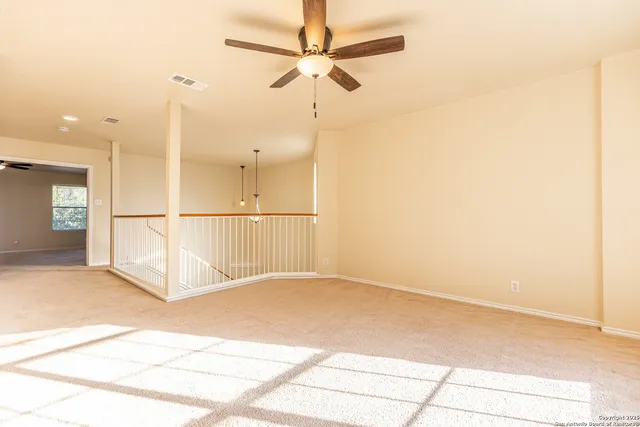 a view of a ceiling fan and a refrigerator