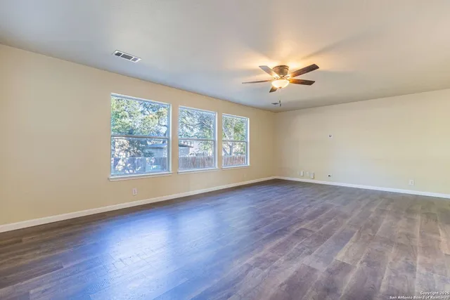wooden floor in an empty room with a window