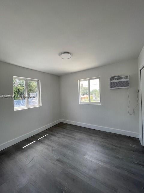 1920 Northwest 151st Street, Unit 3 Opa-Locka, FL 33054 - Photo 6 of 11 a view of an empty room with wooden floor and a window