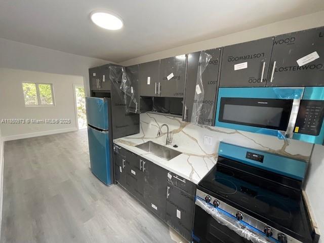 1920 Northwest 151st Street, Unit 3 Opa-Locka, FL 33054 - Photo 7 of 11 a room with furniture and a flat screen tv