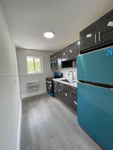 1920 Northwest 151st Street, Unit 3 Opa-Locka, FL 33054 - Photo 8 of 11 a kitchen with stainless steel appliances granite countertop a refrigerator sink and cabinets