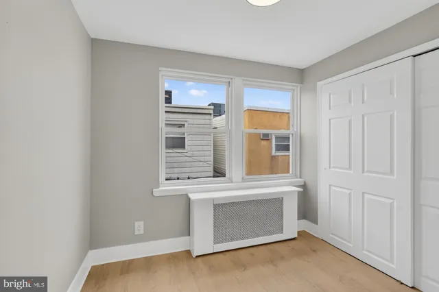 a view of wooden floor and windows in a room