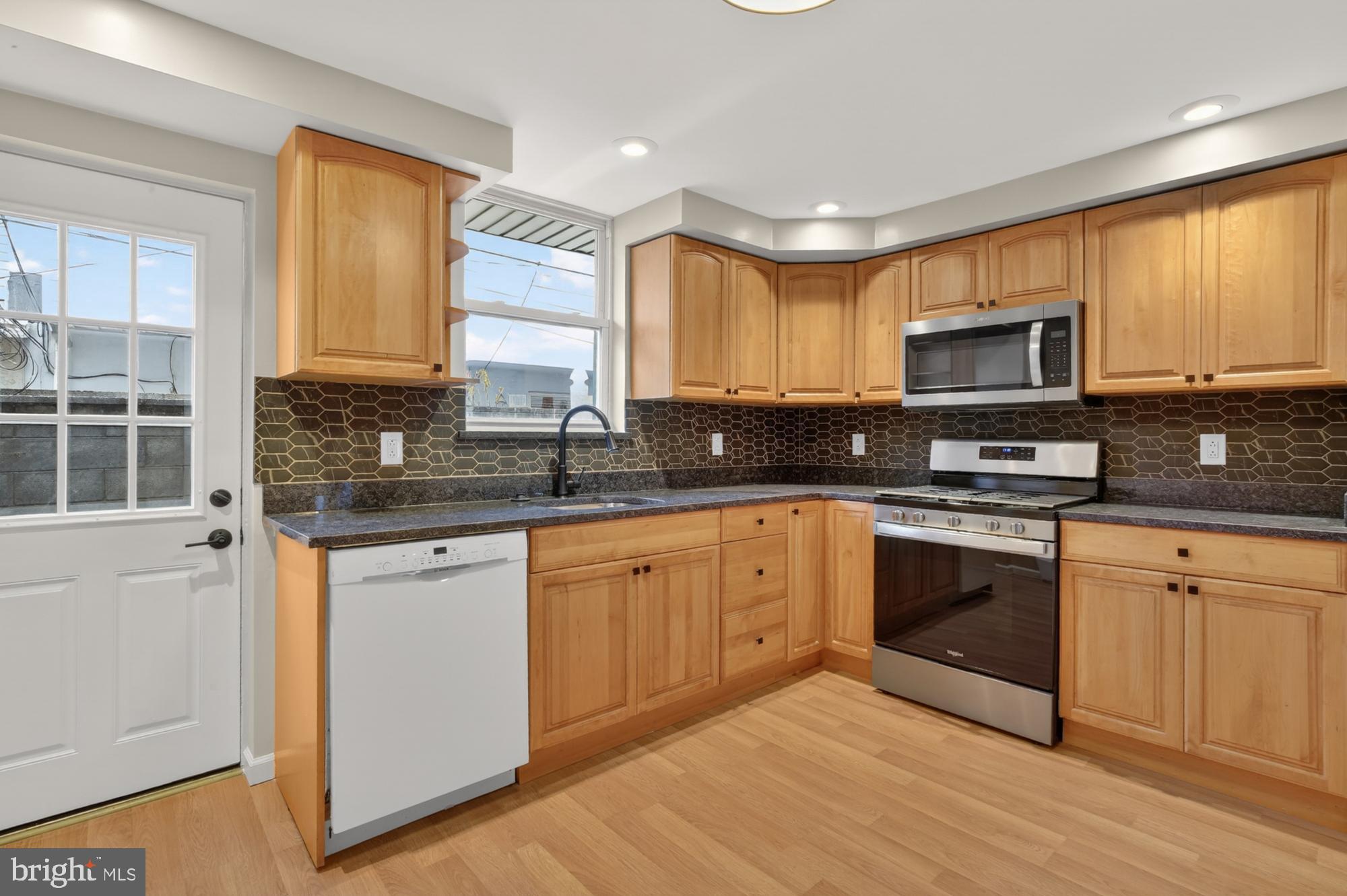 1908 South Jessup Street Philadelphia, PA 19148 - Photo 12 of 28 a kitchen with stainless steel appliances granite countertop a stove a sink and a microwave