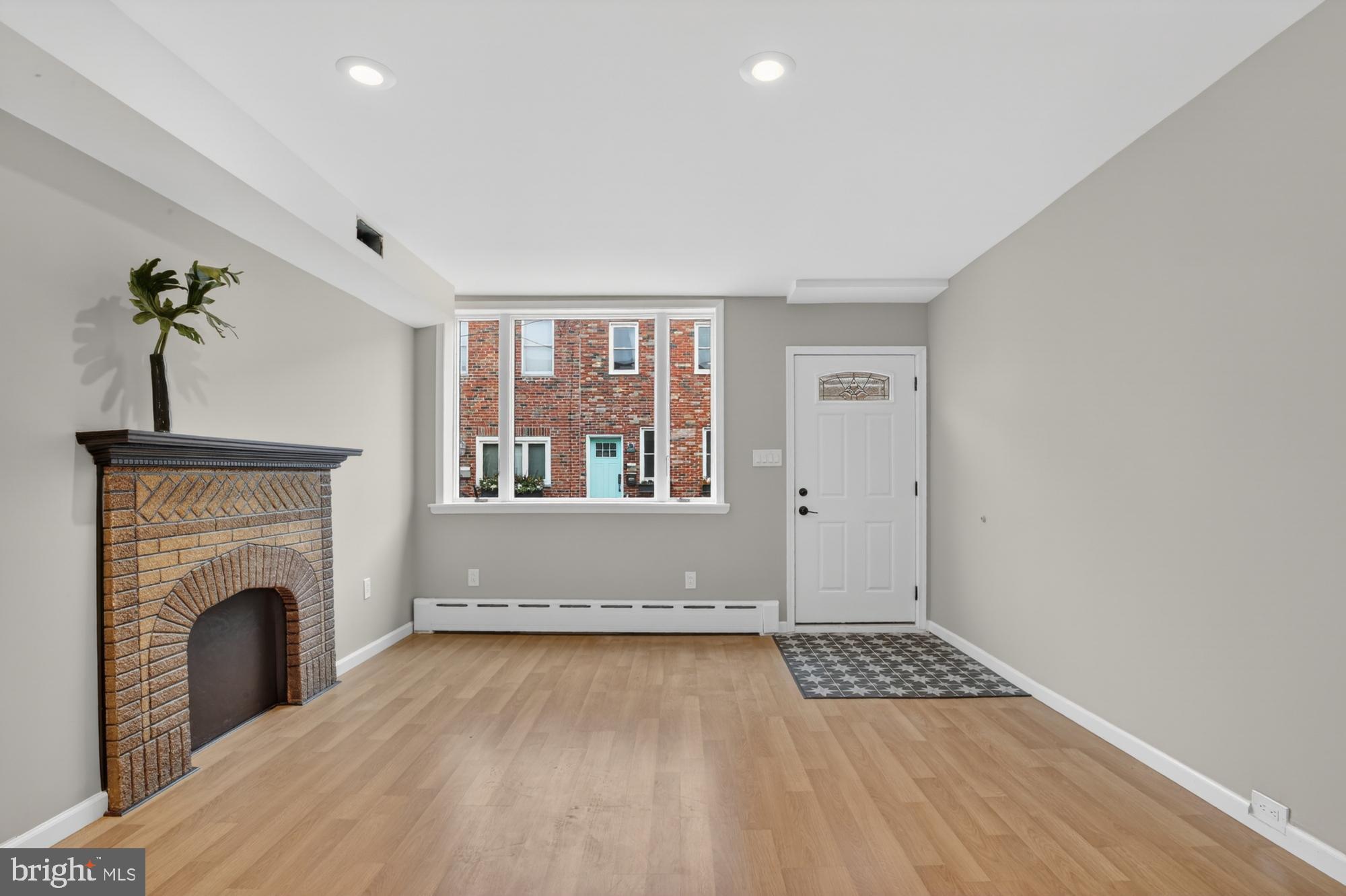 1908 South Jessup Street Philadelphia, PA 19148 - Photo 5 of 28 a view of livingroom with furniture fireplace and window