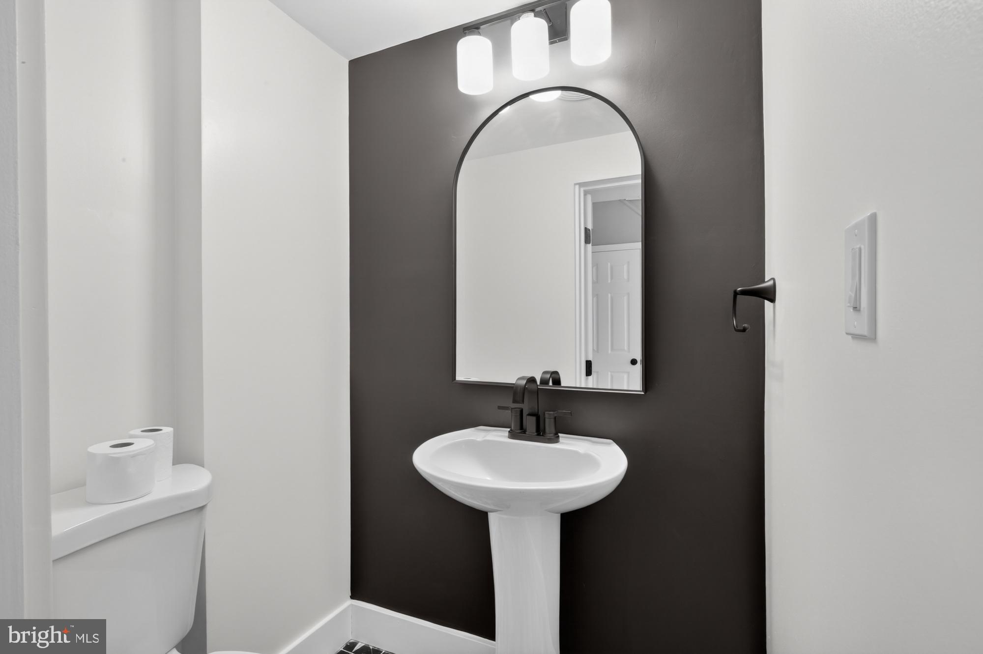 1908 South Jessup Street Philadelphia, PA 19148 - Photo 10 of 28 a bathroom with a sink and a mirror