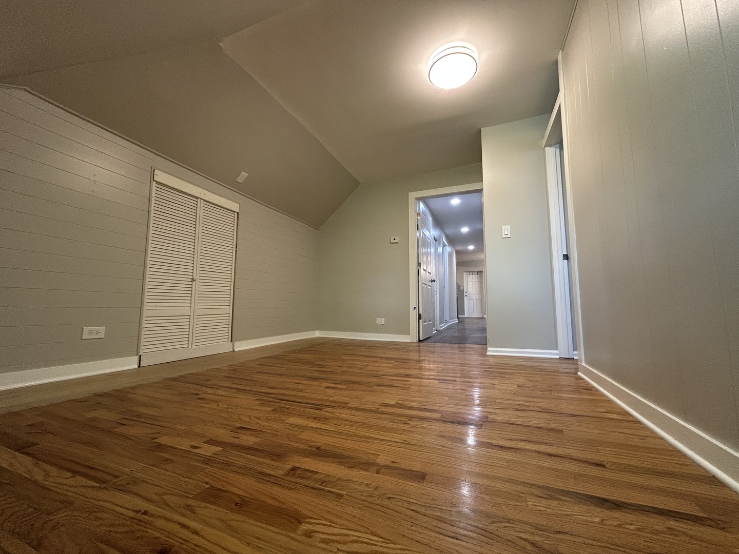 4834 North Ridgeway Avenue, Unit 3 Chicago, IL 60625 - Photo 11 of 12 a view of an empty room with wooden floor and a window