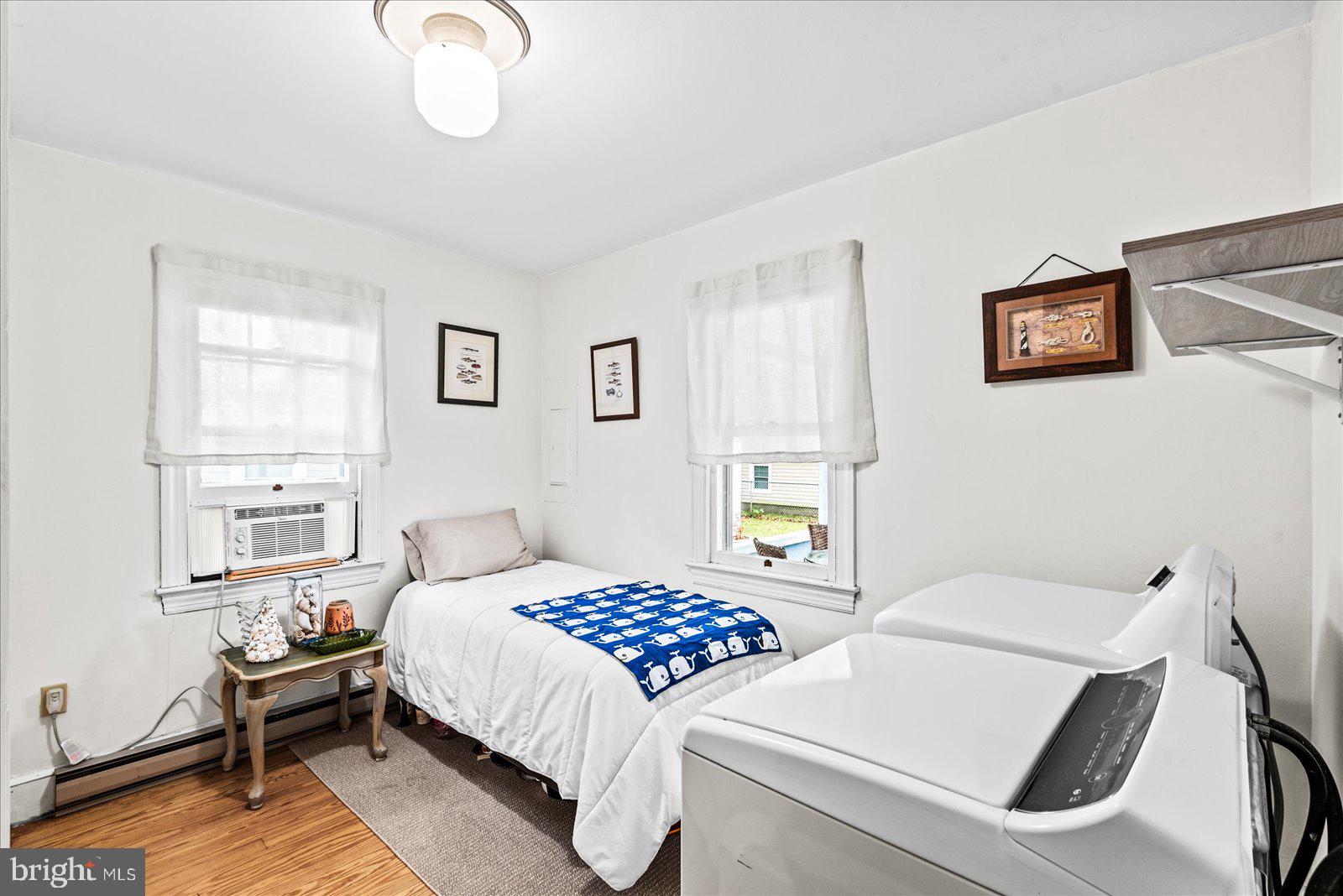 314 Lafayette Street Colonial Beach, VA 22443 - Photo 19 of 41 a bedroom with a bed and a chandelier