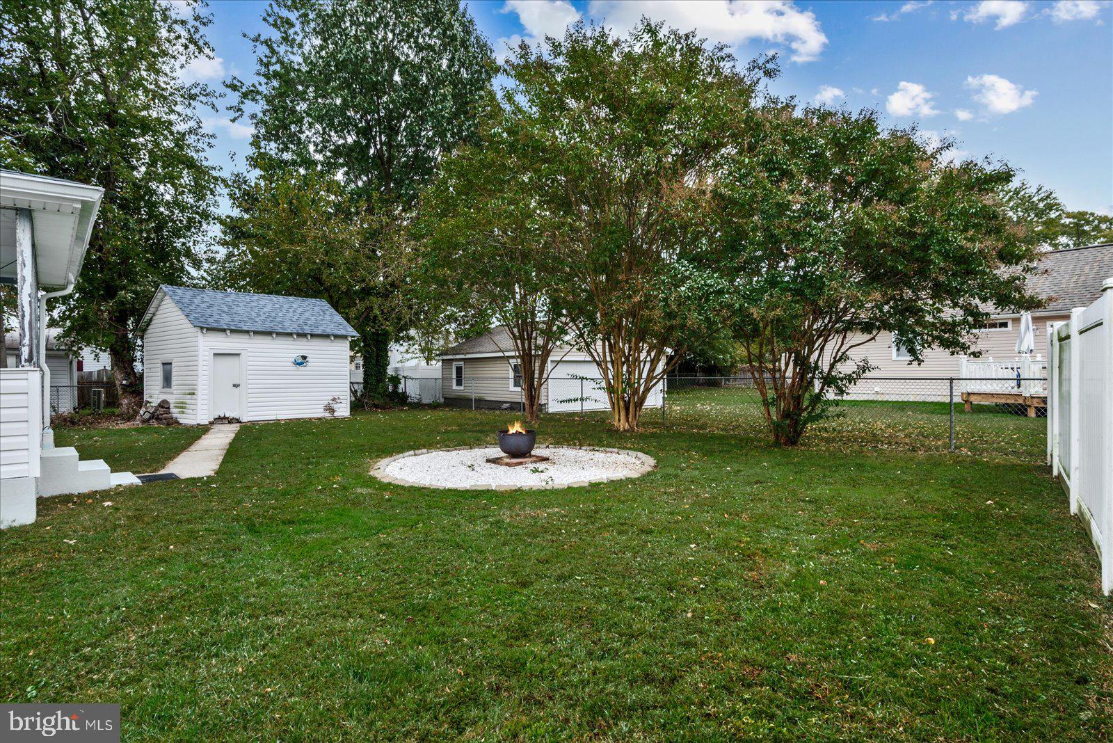 314 Lafayette Street Colonial Beach, VA 22443 - Photo 28 of 41 a view of a house with a backyard and a tree