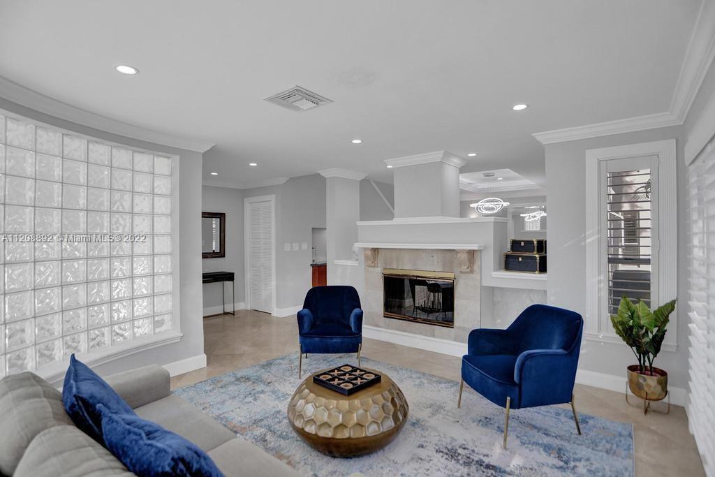 960 Northwest 4th Court Boca Raton, FL 33432 - Photo 16 of 75 a living room with furniture and a fireplace