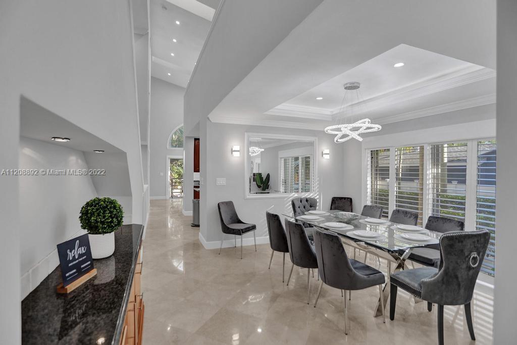 960 Northwest 4th Court Boca Raton, FL 33432 - Photo 19 of 75 a view of a dining room with furniture and chandelier