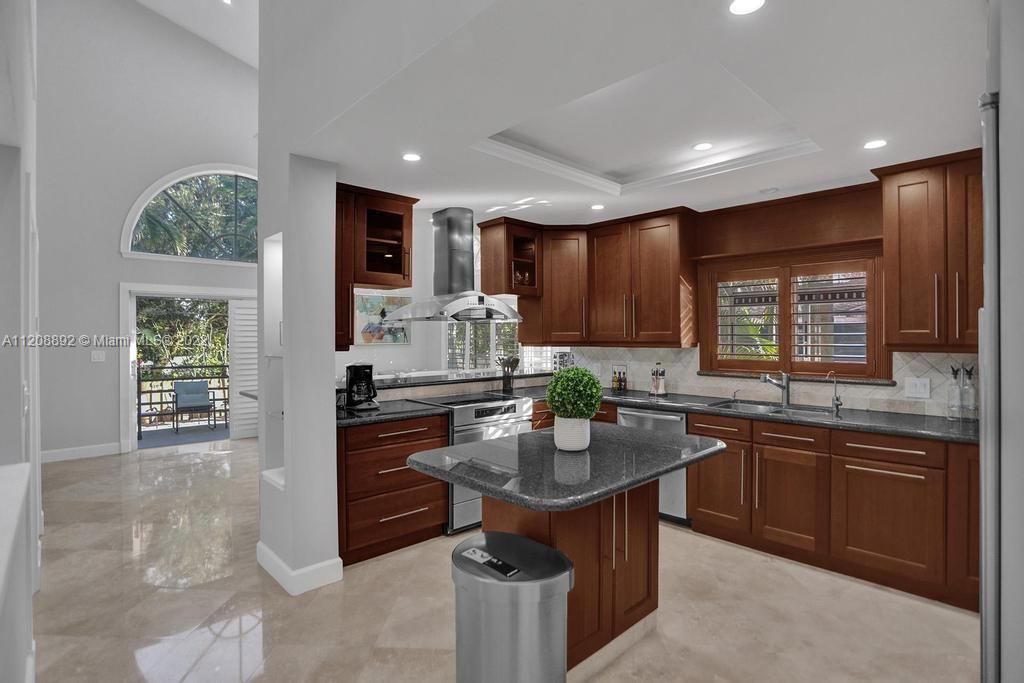 960 Northwest 4th Court Boca Raton, FL 33432 - Photo 22 of 75 a kitchen with stainless steel appliances granite countertop a sink stove and refrigerator