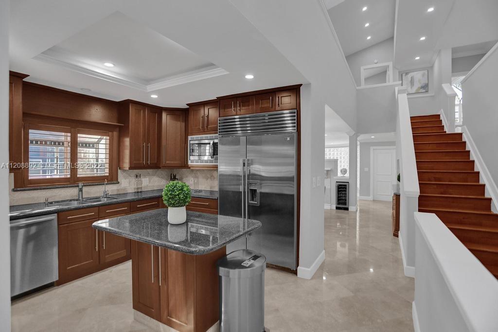 960 Northwest 4th Court Boca Raton, FL 33432 - Photo 23 of 75 a kitchen with stainless steel appliances granite countertop a sink and a refrigerator