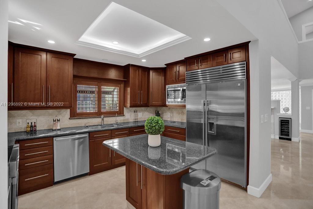 960 Northwest 4th Court Boca Raton, FL 33432 - Photo 24 of 75 a kitchen with stainless steel appliances granite countertop a sink a stove and a refrigerator