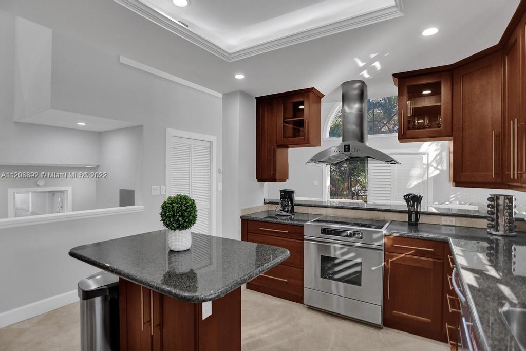 960 Northwest 4th Court Boca Raton, FL 33432 - Photo 27 of 75 a kitchen with stainless steel appliances a sink a stove a table and chairs