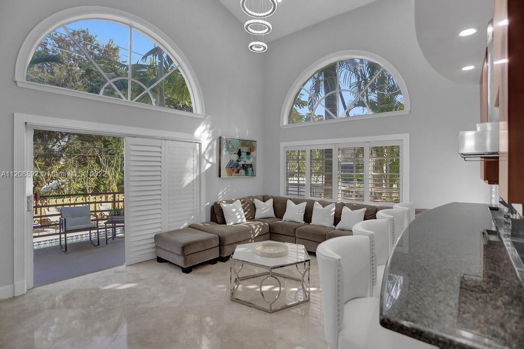 960 Northwest 4th Court Boca Raton, FL 33432 - Photo 30 of 75 a living room with furniture and a large window