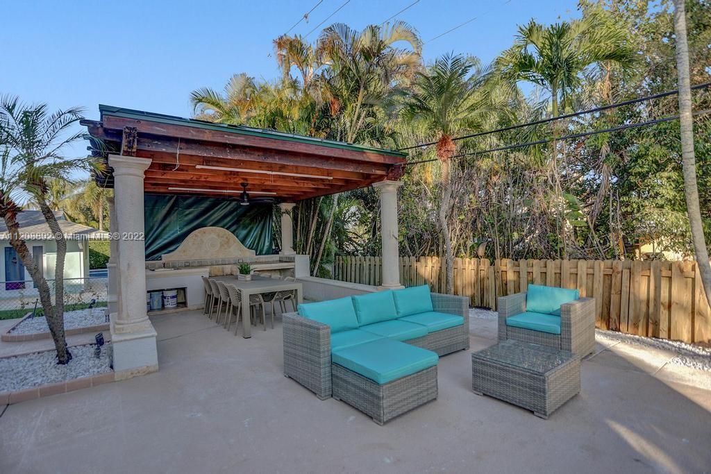 960 Northwest 4th Court Boca Raton, FL 33432 - Photo 3 of 75 a view of outdoor sitting area with furniture and wooden deck