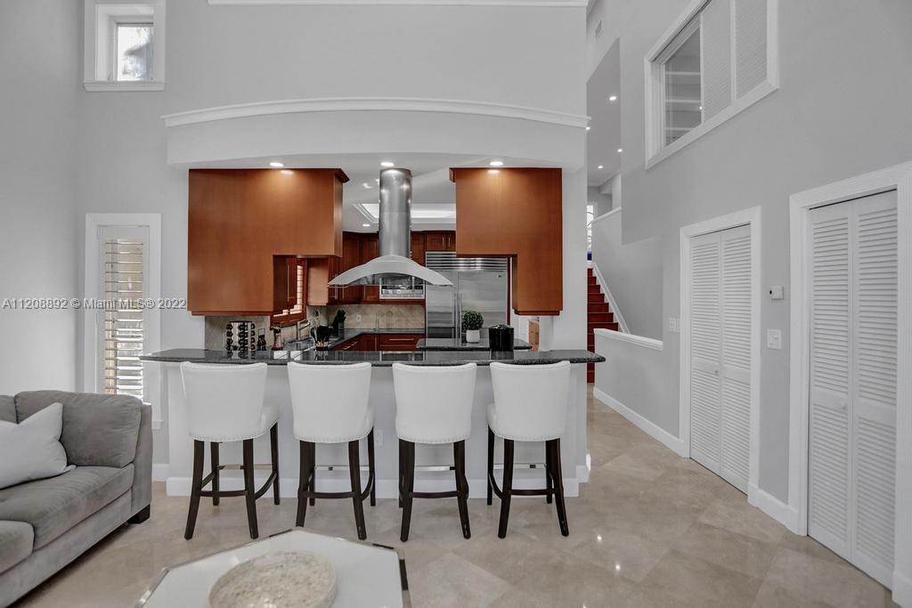 960 Northwest 4th Court Boca Raton, FL 33432 - Photo 33 of 75 a living room with furniture a flat screen tv and kitchen view