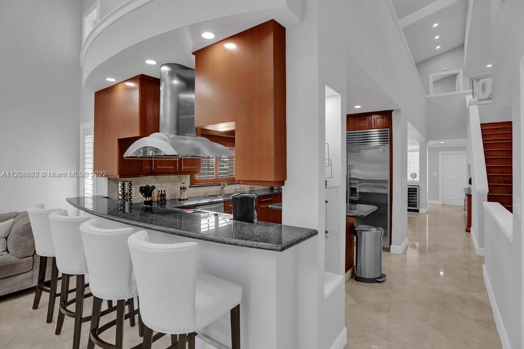 960 Northwest 4th Court Boca Raton, FL 33432 - Photo 34 of 75 a kitchen with stainless steel appliances a sink and cabinets
